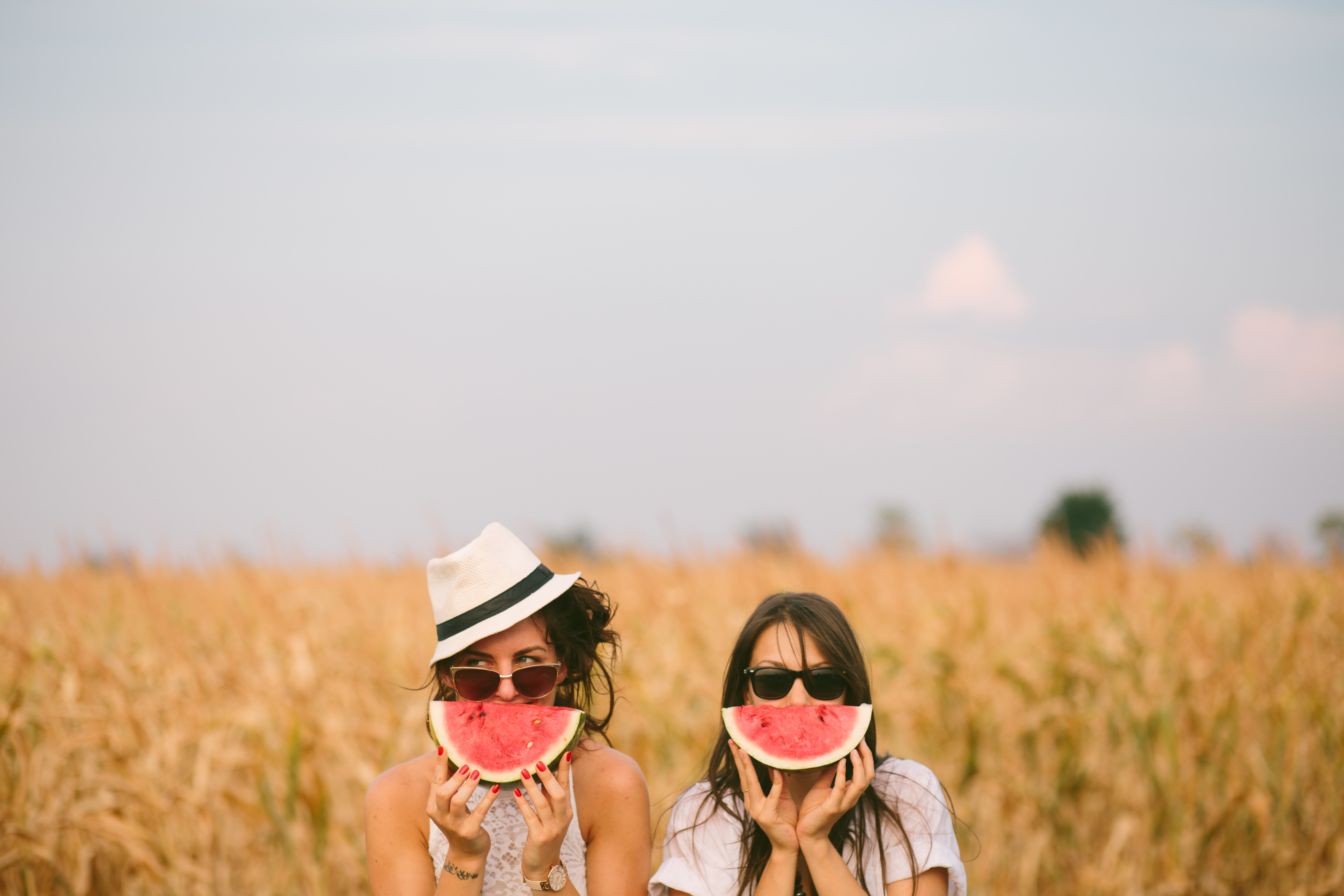Two young woman holding watermelon